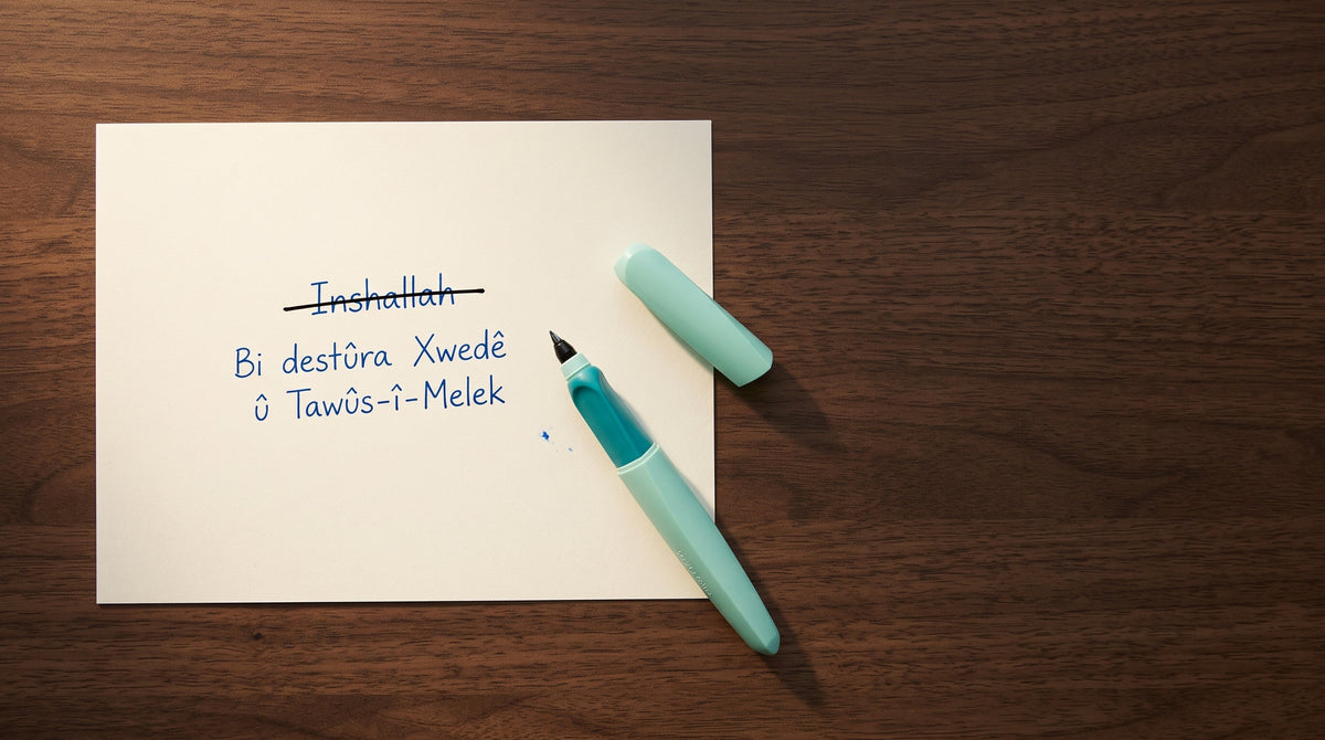 Handwritten phrases on paper beside a black fountain pen